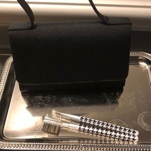 Small black evening handbag with two makeup tools
